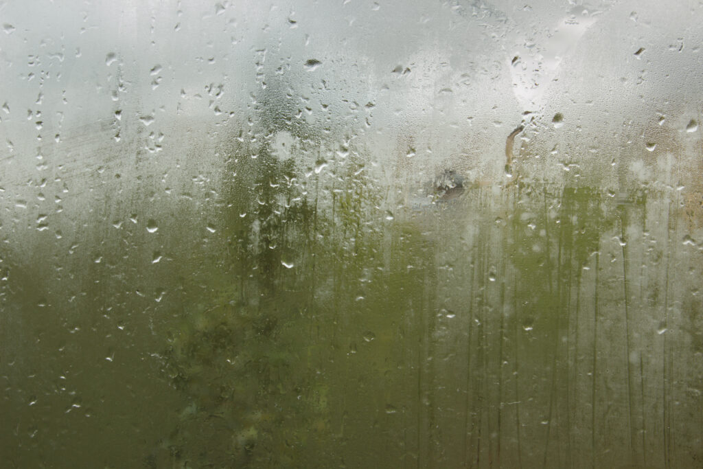 Raindrops on glass. Sorrow. Photo by cherniyvg/Adobe Stock